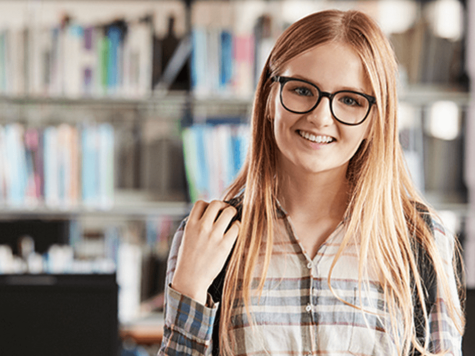 Female middle school student wearing glasses smiling