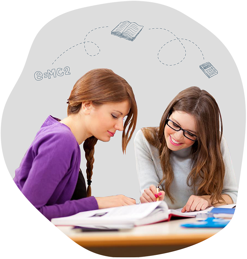 Two female students looking at workbook